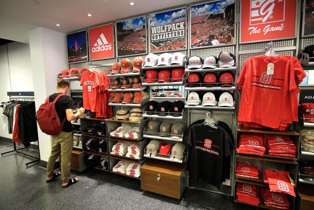 A student browses NC State-branded apparel.